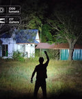 Tiny But Mighty EDC Flashlight Rechargeable 1300 Lumens illuminating a backyard at night, showing 217 meters beam reach.