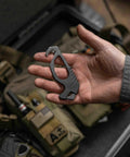 Person holding Pocket Size Seatbelt Cutter Escape Tool With Lanyard Hole And Glass Breaker One Hand Deployment 420HC Steel Hook Knife