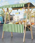 Collapsible Wooden Vendor Cart With Canopy featuring a green striped awning and ample counter space for street food events.