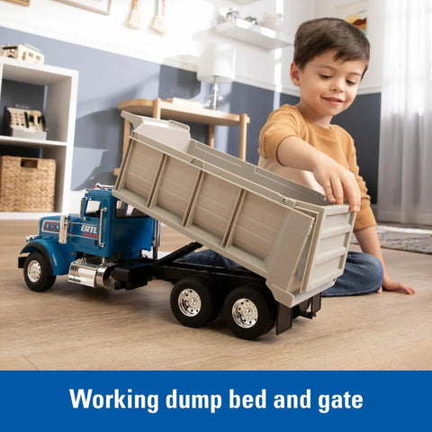 Child playing with Blue Peterbilt 1/16 Scale Dump Truck Toy With Working Dump Bed 20 Inch Construction Vehicle indoors.