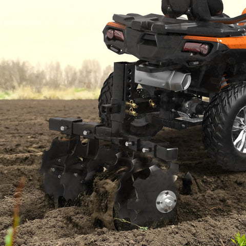Heavy-Duty 28 Inch Disc Plow Harrow With Universal 2 Inch Receiver Hitch Pull-Behind Plow attached to ATV in field