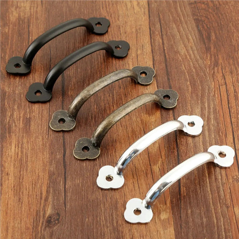 Assorted finishes of Vintage 85mm Drawer Knob Set For Cabinets And Dressers, 4 Pack Wooden Jewelry Box Pull Handles, Dope Decorative Furniture Hardware With Screws, Cool Modern Classic Kitchen Cupboard Pulls on a wooden surface.