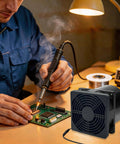 Compact 120mm DC Soldering Fume Extractor Fan With Filter Pad And Duct Kit Adjustable Speed Plug And Play For Welding Smoke Soldering Laser 3D Printer Enclosures Easy DIY Ventilation in use on a workbench during soldering.