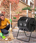 Heavy Duty 42 Gallon Dual Chamber Outdoor Compost Tumbler with Sliding Doors shown in garden setting with person raking leaves
