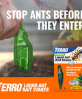 Person inserting green bait stake, Terro Liquid Ant Bait Stakes packaging displayed, outdoors with plant, hand close-up.