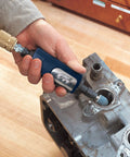 Rugged 1/4 Inch Pneumatic Die Grinder Packing Hella Fast 25000 RPM Power in use for deburring metal engine part.