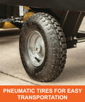 Close-up of pneumatic tire on Heavy Duty Steel Tow Behind Dump Cart With 350 Pound Capacity 10 Cubic Feet Bed