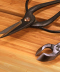 Solid Bonsai Tools Essentials Set With 8 Inch Concave Cutter And 7 Inch Heavy Duty Shear For Precise Trimming Hand Forged Carbon Steel Blades Ergonomic Grip Great For Beginners And Pros close-up on bamboo board