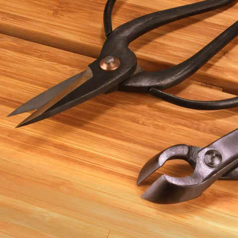 Solid Bonsai Tools Essentials Set With 8 Inch Concave Cutter And 7 Inch Heavy Duty Shear For Precise Trimming Hand Forged Carbon Steel Blades Ergonomic Grip Great For Beginners And Pros close-up on bamboo board