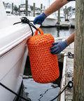 Placing an orange Solid Nylon Boat Fender For Docking And Marine Anti Collision Protection beside a docking boat