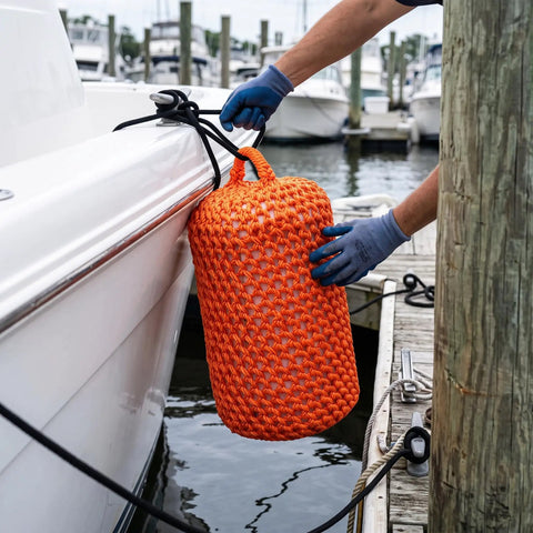 Placing an orange Solid Nylon Boat Fender For Docking And Marine Anti Collision Protection beside a docking boat