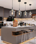 Modern Black And Gold Glass Pendant Light 2 Pack With Adjustable Height Cord For Kitchen Island Clear Round Shade E26 Socket above a kitchen island.