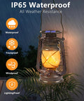 Outdoor Solar Lanterns 2 Pack Waterproof Bronze Flickering Flame Lights for Garden Patio and Yard showing in rainy weather