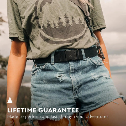 Original Unisex Adventure Belt With Heavy Duty Elastic Webbing And Non Metal Travel Buckle For Active Lifestyles Medium Brown worn outside