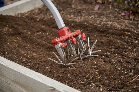 Disc Cultivator Heavy Duty Garden Tool With ComfortGEL Grip adjustable six and a half inch metal tines in raised bed.