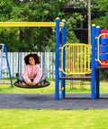 Child sitting on Saucer Tree Swing For Kids, 24 Inch Net Seat Disc Round Swing, in colorful playground setting
