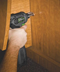 Hand holding Close Quarter Drill With Non Slip Grip 3.5 Amp Motor Variable Speed 0 To 1600 RPM Three Eighths Inch Chuck in cabinet