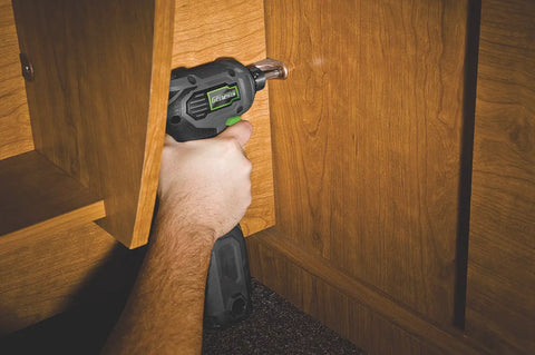 Hand holding Close Quarter Drill With Non Slip Grip 3.5 Amp Motor Variable Speed 0 To 1600 RPM Three Eighths Inch Chuck in cabinet