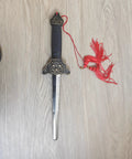 Scalable Tai Chi Training Sword with collapsed 35.4 inch extendable blade, ABS handle and tassel, viewed on wooden surface