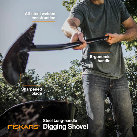 Person using a Fiskars steel long-handle digging shovel with ergonomic handle and sharpened blade, in a garden setting.