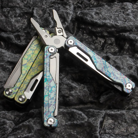 Camouflage Titanium Multitool Pliers Built Beefy With 420 Stainless Plier Head And 440 Steel Accessories on rocky surface