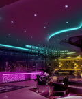 Colorful room lit with Waterproof Led Strip Lights 32.8 Ft Two Rolls Of 16.4 Ft Color Changing 300 LEDs, showing ceiling design