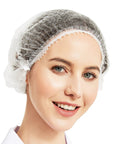 Person wearing 500 Pack White Disposable Hair Nets Bouffant Caps Elastic Head Covers For Food Service And Spa Use 21 Inch