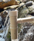 50W Pipeline Spiral Hydroelectric Generator in stream with rocks, permanent magnet brushless micro turbine visible