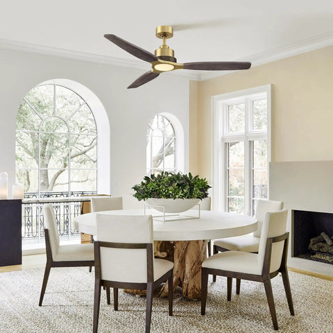 56" Soft Brass Chandelier Ceiling Fan,2 Downrods Fandelier with Remote above a modern dining table with solid wood base.