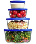 Stacked Glass Bowls Set Of Four With Lids, 1, 2, 4 And 7 Cup Sizes, filled with diverse foods, blue lids shown in use