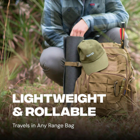 Person packing Reusable Self Healing Rubber Archery Target Face Roll Up Practice Target Sheet into a bag, outdoors.