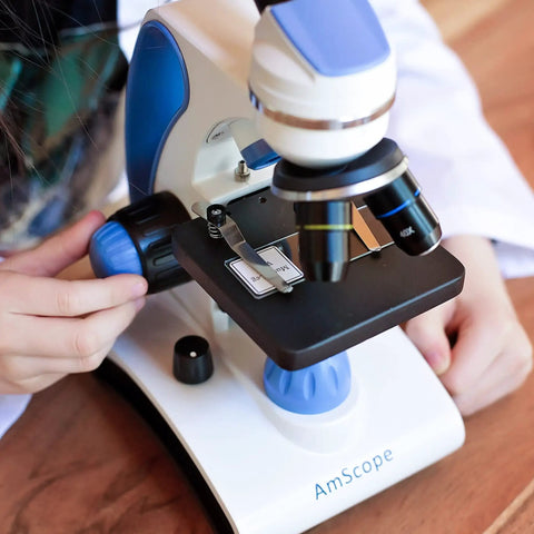 Child using Beginner Microscope Kit With Dual LED Lights 40X To 1000X Magnification For Kids And Students Includes Complete Science Accessory Kit And World Of The Microscope Book
