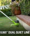 Side view of 40V Cordless String Trimmer with 12 Inch Cutting Path trimming grass along a brick edge in a garden setting.