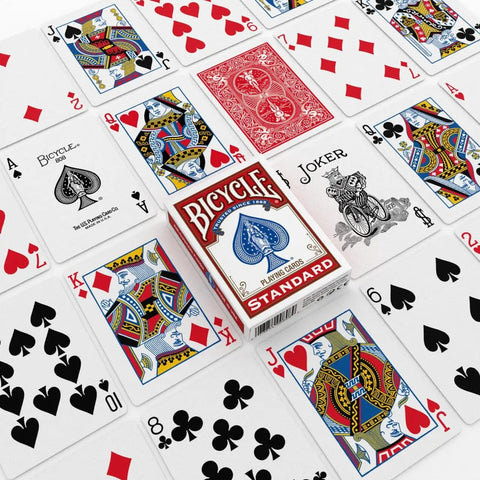 Standard Two Pack Playing Cards In Red And Blue Optimized For Tight Fan And Buttery Smooth Shuffle Heavy Duty Stock on table.