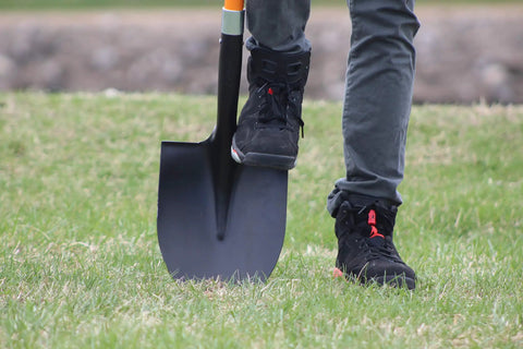 Heavy Duty Digging Shovel 41 Inch With Trenching Blade And Comfortable Handle For Garden Landscaping Construction And Masonry A Do It All Shovel For Digging Soil Dirt And Gravel being used on grass