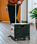 Person using Collapsible Rolling Cart With Lid And Handle 35L 4 Wheel Utility Crate Folds Flat To 3.5 Inches Holds 75 Lbs in hallway