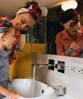 Mother and child brushing teeth in bathroom with Three Pack GFCI Outlet 20 Amp with LED Indicator on the wall
