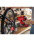 Person using V20 Cordless Tire Inflator And Portable Air Compressor With Digital Pressure Gauge Up To 150 Psi on a bicycle tire