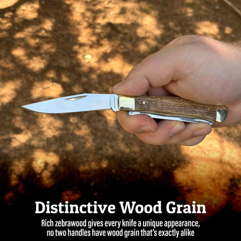 Scout Trapper Dual Blade Pocket Knife 3-Inch Clip Point And 3-Inch Spey Blades in hand showing zebrawood handle.