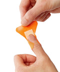 Person applying The Real Deal Fingertip And Knuckle Bandages With Extreme Hold Adhesive, Durable Fabric Antibacterial Wound Dressings.