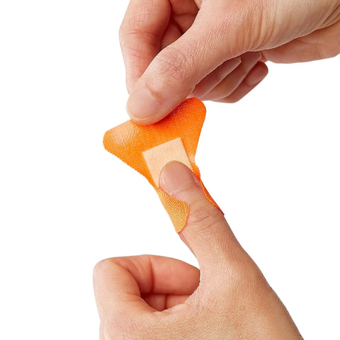 Person applying The Real Deal Fingertip And Knuckle Bandages With Extreme Hold Adhesive, Durable Fabric Antibacterial Wound Dressings.