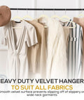 50 Pack Ultra Slim Velvet Closet Hangers Top Shelf Non Slip Felt Coat Jacket Dress Organizers Space Saving Closet Game Heavy Duty Swivel Hook Smooth Glide Ivory with various garments hanging.