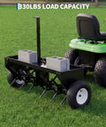 Heavy Duty 48 Inch Tow Behind Plug Lawn Aerator With Universal Hitch Deep Soil Penetration Steel Tines Tray And Inflatable Wheels For Lawns Gardens And Farms Unbreakable Steel Chassis Black attached to a lawn tractor