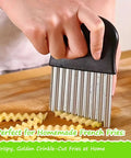 Hand-held large wavy crinkle cutter with stainless steel blades and black plastic handle slicing potatoes into fries