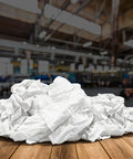 Bulk White Cotton Cleaning Rags Recycled T Shirt Rag Pack 5 Lb Compressed Box For Oil Grease Paint Stain Cleanup Auto Care Multipurpose Absorbent Garage Towels on wooden surface in an industrial setting