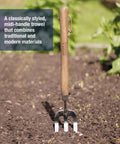 Stainless Steel Hand Weeder Fork For Easy Weeding And Soil Aeration in garden soil with ergonomic wooden handle