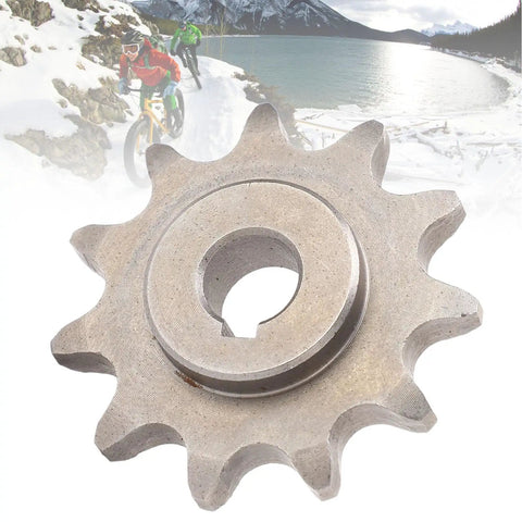 Close-up of 420 11-Tooth Motor Sprocket with Keyway, steel component, suitable for MY1020, MY1016Z, MY1018 motors, with cyclists in background.