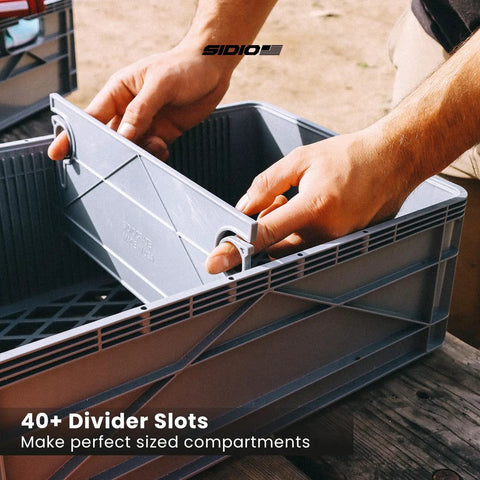 Hands adjusting divider in Heavy Duty Stackable Storage Bins With Standard Dividers Rock Solid Blue Plastic Crates For Garage And Closet.