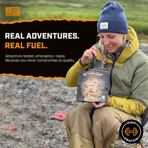 Woman in outdoor gear holding Hearty Beef Stroganoff Freeze Dried Backpacking Meal Just Add Water Made With Real Meat.