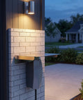 Heavy Duty EV Charger Protector Stainless Steel Weatherproof Enclosure mounted on brick wall with light, perfect for outdoor use.